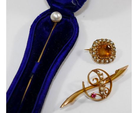 A Victorian yellow topaz and half pearl cushion shaped gold brooch, a cultured pearl topped stick pin and a 9 carat gold gem 