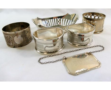 A small oval silver dish, with pierced sides, 9.5cm long, a pair of D-shaped silver napkin rings with engine turned decoratio