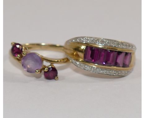 A 9 carat gold garnet and amethyst three-stone cross over ring, finger size P, 2.1g gross, and a 9 carat gold diamond and alm