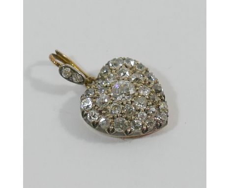 A diamond set heart-shaped pendant the old cut diamonds in open back setting the centre stone approximately 0.20 carats withi