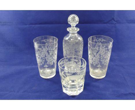 An Edwardian decanter with wheel engraved decoration, 22.5cm high and two large matching beakers, 14.5cm high, and a panel cu