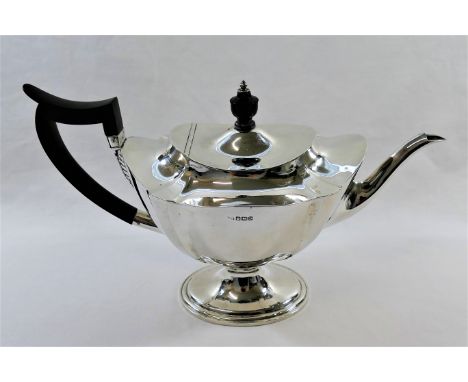 A silver pedestal teapot, Sheffield 1913 by Mappin and Webb, with ebonised handle and knop, 19cm high, 21.85ozt, 679.5g CONDI