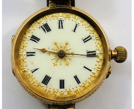 A Continental yellow metal cased pocket watch, converted to a wrist watch, the white enamel face with Roman numerals and gilt