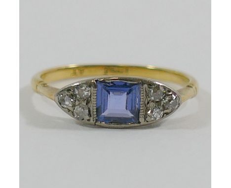 An early 20th century sapphire and diamond ring, the square mixed cut sapphire rub-over set between six eight-cut diamonds, t