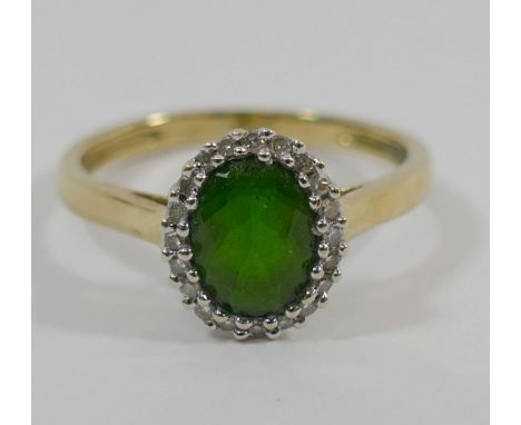 A 9 carat gold chrome diopside and diamond oval cluster ring, Birmingham 2009, the bright green oval mixed cut diopside set w