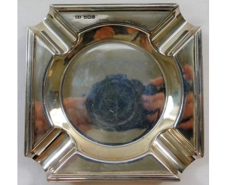A square section silver ashtray, Sheffield 1944, with cigarette rests to each corner leading to a circular centre, 9.3cm acro