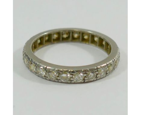 An early 20th century diamond eternity ring, the 24 small round old-cut diamonds each approximately 0.05 carats, finger size 