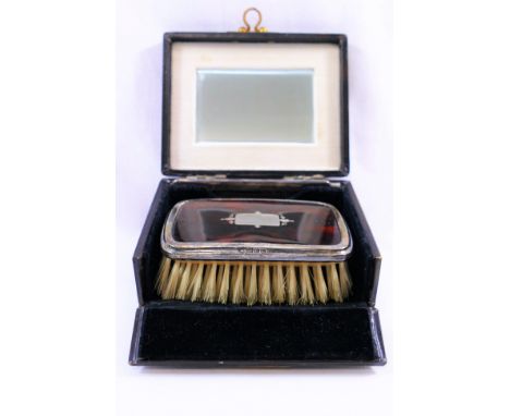 A George V silver and tortoiseshell backed rectangular hairbrush, Birmingham 1927 by William Hutton and Sons Ltd, 9cm x 6cm, 