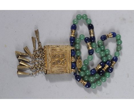 A JADE ISLAMIC NECKLACE AND GILT PENDANT.