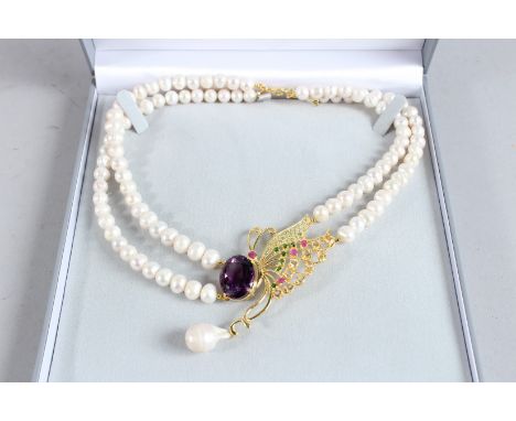 A SILVER AND GOLD PLATED, AMETHYST AND RUBY BUTTERFLY PEARL NECKLACE.