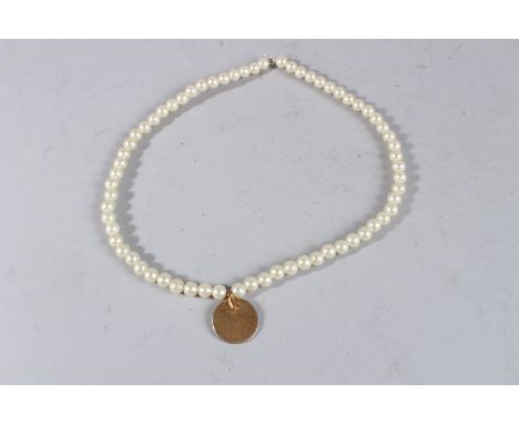 A PEARL NECKLACE with a gilt coin.
