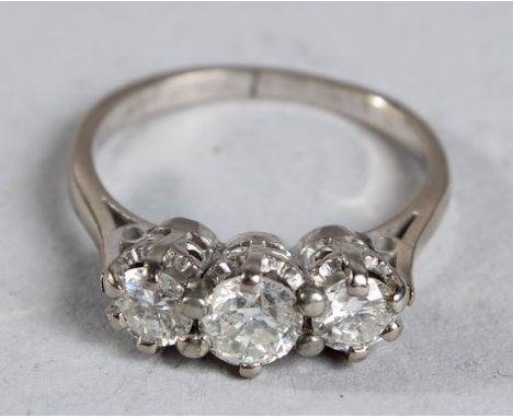 A THREE STONE DIAMOND RING in 18ct white gold.