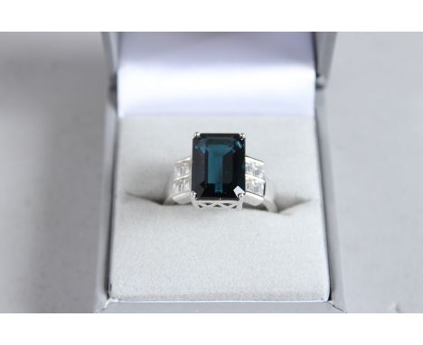 A SILVER ART DECO DESIGN LONDON BLUE TOPAZ RING.