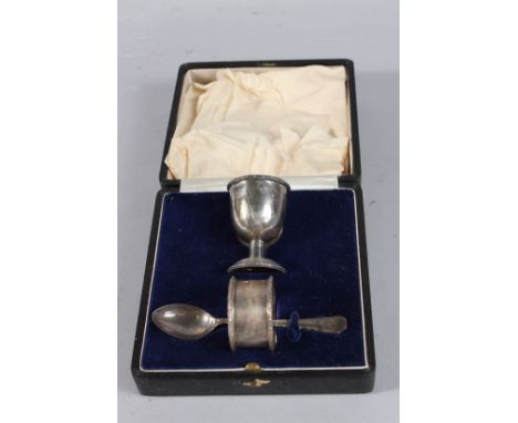 A CASED SILVER CHRISTENING SET, egg cup, spoon and serviette ring. Sheffield 1935.