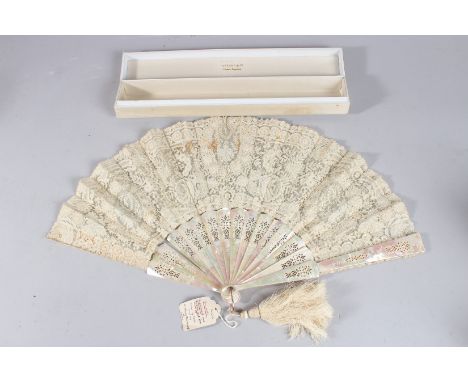 A TIFFANY &amp; CO BRUSSELS NEEDLEPOINT AND BOBBIN LACE FAN IN MOTHER-OF-PEARL. 19ins wide open, in a Tiffany &amp; Co box.