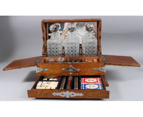 A GOOD EDWARDIAN THREE BOTTLE WHISKY TANTALUS AND GAMES COMPENDIUM, fitted with three whisky decanters and stoppers, chess pi