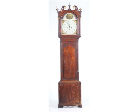 A late 18th Century oak longcase clock 
With a twin swan-neck pediment above a break arch painted dial, the thirteen inch dia