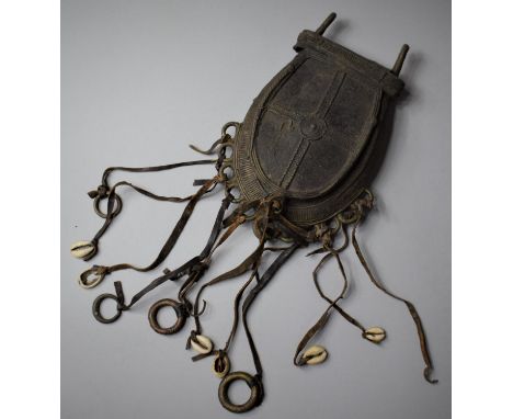An African Benin Bronze Pouch with Leather Tassels Decorated with Seashells etc, 20cm high 