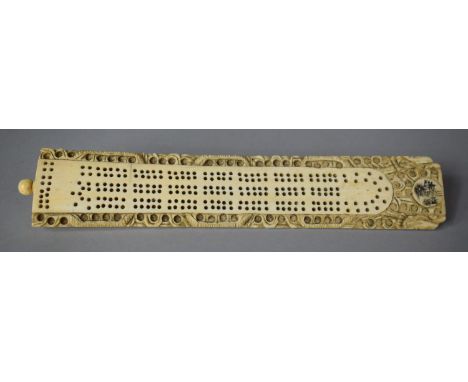 A 19th Century Cantonese Ivory Cribbage Board Having Inner Store Containing Coloured and Plain Peg Markers, 20cm long 