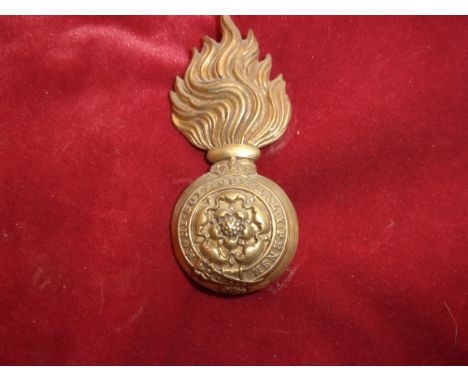 The Royal Fusiliers (City of London Regiment) Other Ranks Head Dress Badge for the Raccoon-skin cap, first type (Brass) two l