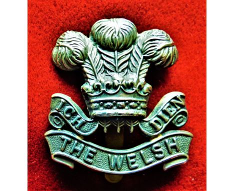 The Welsh Regiment Other Ranks Cap Badge (White-metal), slider, in 1930 the wording the scroll turned to 'Welch'. K&amp;K: 65