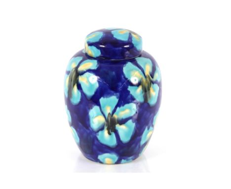 A Poole Studio pottery jar and cover, initialled to base "WYJ.T" multi coloured floral decoration, 26cm high 
