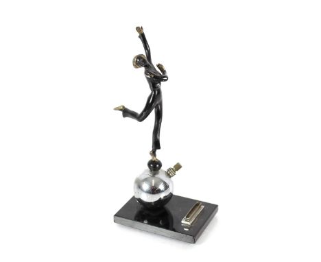 An Art Deco chrome and spelter table lighter in the form of a dancer, raised on an onyx plinth, 24cm 