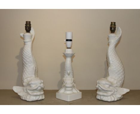 A pair of Casa Pupo ceramic lamp bases in the form of dolphins , 40cm high; and a smaller similar 36cm high 