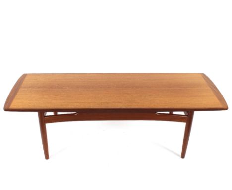 A 1970's teak G-plan design long coffee table raised on rounded tapering supports, 134cm long