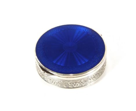 A Sterling silver circular pot with blue enamel decorated lid and engraved floral border to the main body, mirrored inside, t