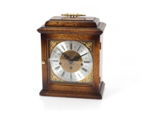 A 20th Century oak cased chiming mantel clock by Franz Hermie, brass spandrel dial and steel chapter ring surmounted by a bra