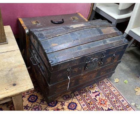 A Victorian wood and iron bound domed trunk, width 78cm, height 54cm, together with a smaller later cabin trunk