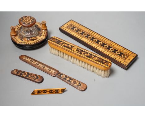A group of Tunbridge ware to include an inkstand, two paper knives (one a handle only), cribbage board, a brush and a brooch