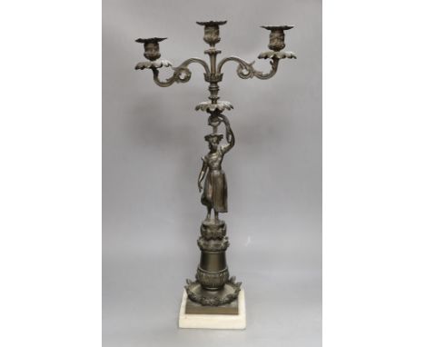 A bronzed spelter figural three light candelabrum, 60cms high