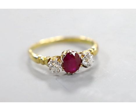 A yellow metal, single stone ruby and two stone diamond set ring, size N, gross weight 2.7 grams.