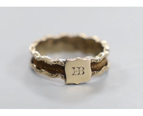 A 19th century yellow metal and plaited hair set band, the ring head with engraved monogram, size M/N, gross weight 1.8 grams