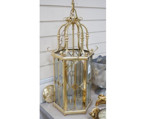 A hexagonal brass and bevelled glass hall lantern, 70 cms high,