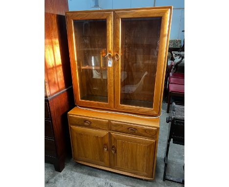 An Ercol elm 'Windsor' glazed side cabinet, width 91cm, depth 43cm, height 162cm