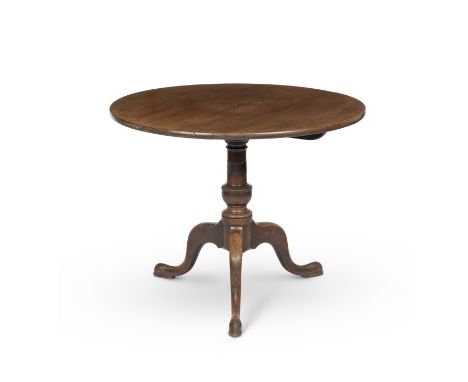 A George III mahogany tripod tableThe circular tilt-top on a turned support with downswept legs and pad feet, and tripod base