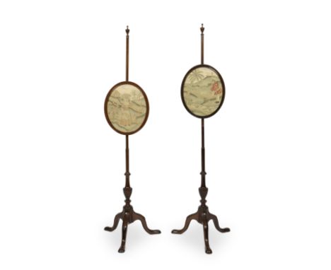 A pair of mahogany pole screensEarly 20th century in the George II styleWith glazed oval needlework panels depicting pastoral