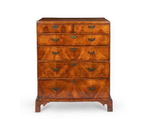 A George I walnut tall caddy-top chestOf two short and four long drawers with ebony and holly stringing on bracket feet, rest
