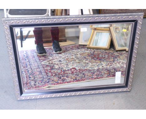 A wall mirror with beveled plate 29" X 19 1/2"