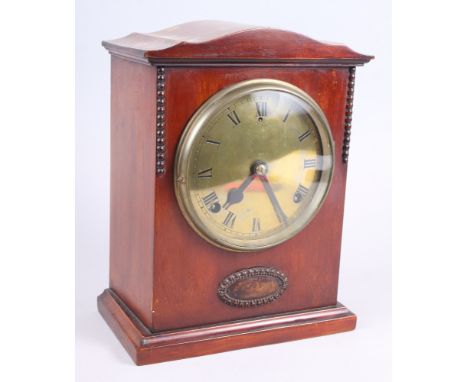 A 1920s polished as walnut mantel clock with brass dial, 19" high