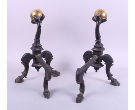 A pair of wrought iron fire dogs with brass ball finials, 13 1/2" high, an African hide mounted double-ended spear, 70" long,