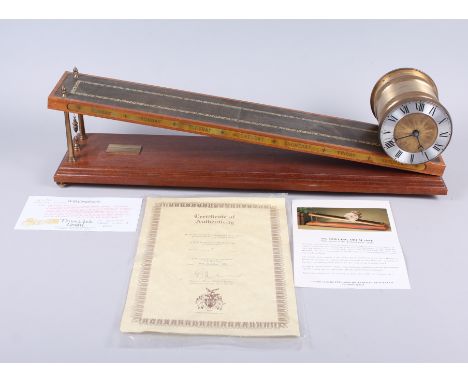 A rolling drum clock, by Devon Clocks, 24" wideCondition: Stays on incline, ticks at present moment, condition appears good.
