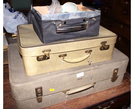 A dentist's travelling case with tools and accessories and two Antler "snakeskin" suitcases