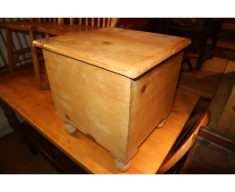 A Victorian stripped pine box seat commode with hinge lid, on bun feet, 17" wide, and a mahogany and inlaid television cabine