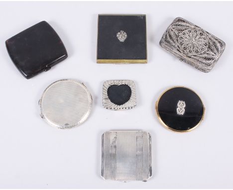 Two engine turned silver powder compacts, two other powder compacts, a white metal filigree cigarette case, a tortoiseshell c