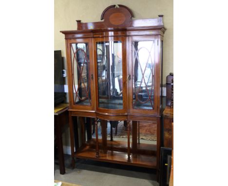 An Edwardian walnut and satinwood banded break bowfront display cabinet enclosed two doors over underteir with mirror back, 4
