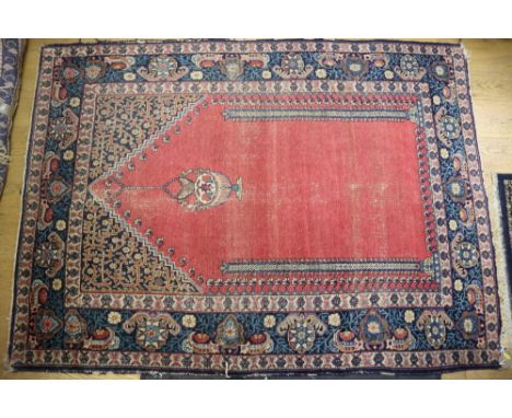 A Persian prayer rug with red central ground, flanking columns and a lantern, 55" x 76" approx (wearing)